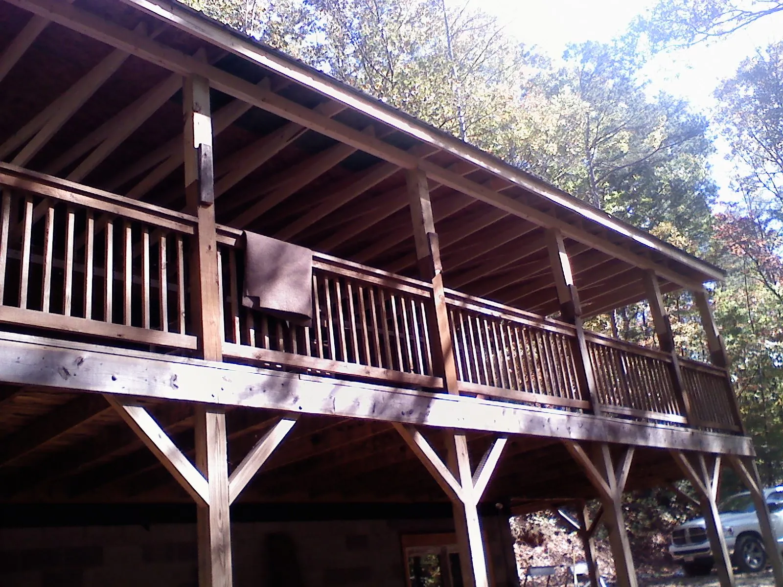 Timber framing under a new elevated porch and deck — Roof Leak Repair in May by Roofing Brothers